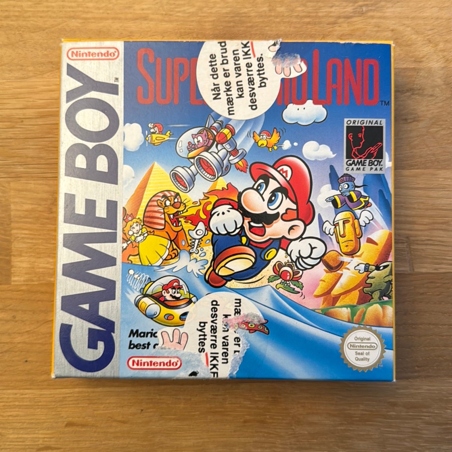 A copy of Super Mario Land with large stickers in norwegian or danish stating that the item cannot be returned if the seal is broken